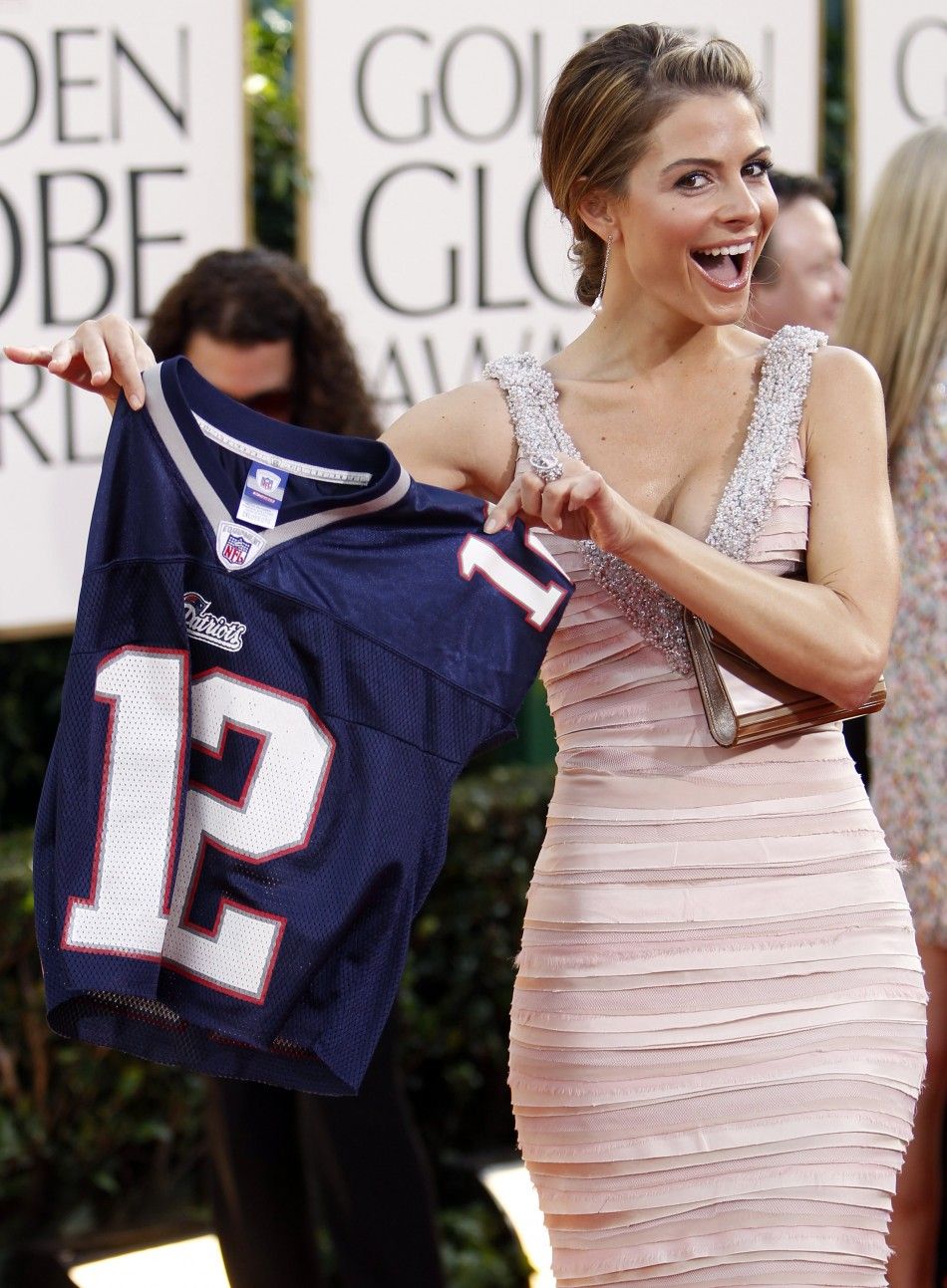 Actress Maria Menounos holds up a Tom Brady Patriots jersey as she arrives at the 68th annual Golden Globe Awards