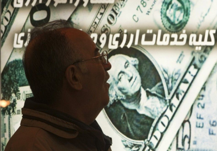 An Iranian man walks past a currency exchange shop in northern Tehran January 3, 2012.