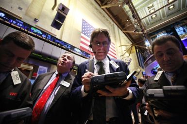 Traders gather at a post on the floor of the New York Stock Exchange February 3, 2012.