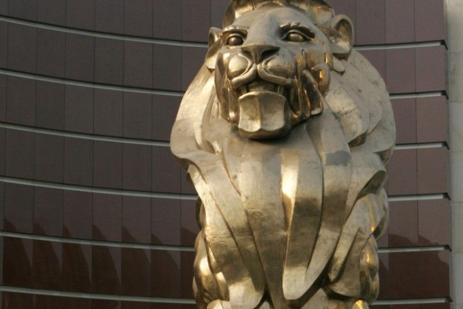People walk past a giant lion sculpture at the MGM Grand Macau hotel resort in Macau