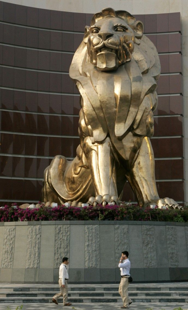 People walk past a giant lion sculpture at the MGM Grand Macau hotel resort in Macau