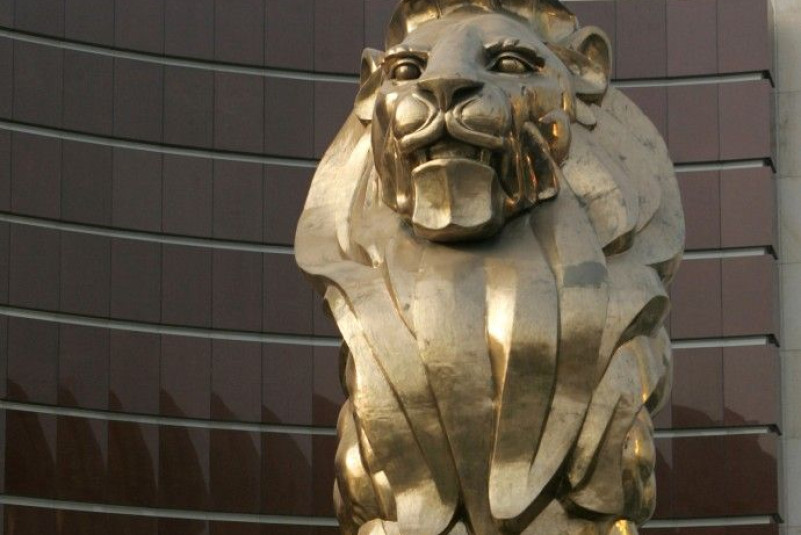 People walk past a giant lion sculpture at the MGM Grand Macau hotel resort in Macau