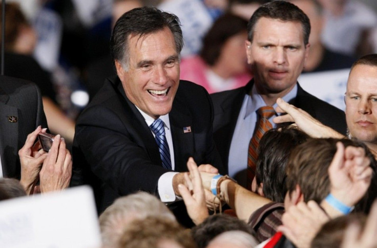 U.S. Republican presidential candidate and former Massachusetts Governor Mitt Romney shakes hands with supporters while giving a speech at his Nevada caucus night rally in Las Vegas, Nevada, Feb. 4, 2012.