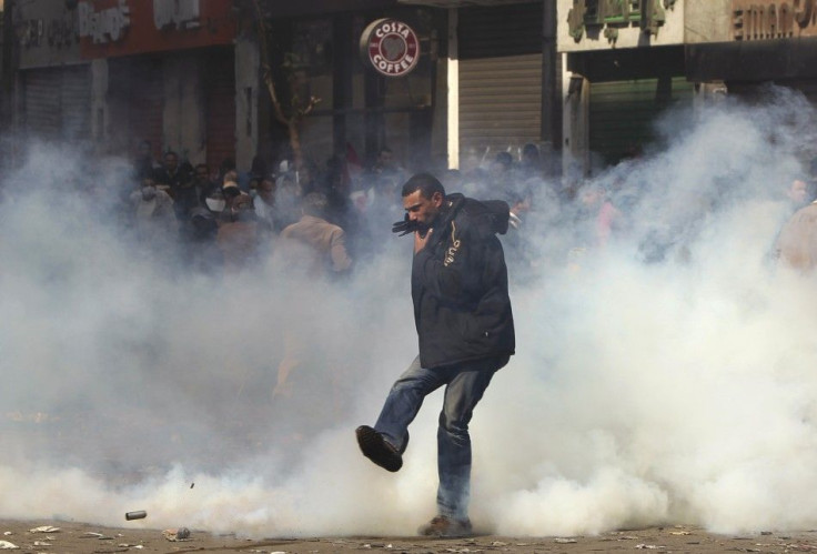 A protester kicks a tear gas canister during clashes with security forces near the Interior Ministry in Cairo February 4, 2012.