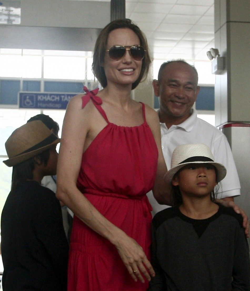 Angelina Jolie stands with her adopted son Pax Thien from Vietnam at a security check point before leaving Con Dao island