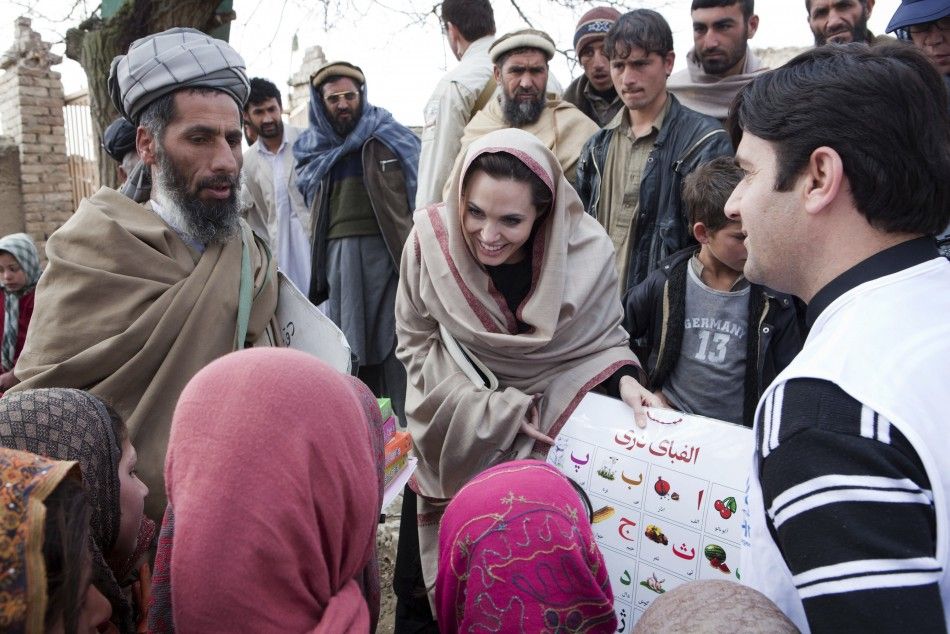 Angelina Jolie presenting education materials in the village of Qala Gudar