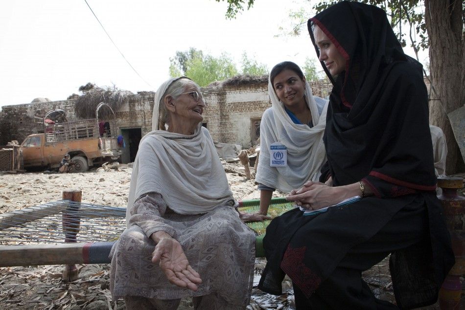 Angelina Jolie meets 64-year-old Zenul Hawa at her flood damaged home in the village of Mohib Bandi