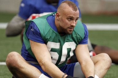 New York Giants linebacker Mark Herzlich (58) stretches during practice for the NFL Super Bowl XLVI in Indianapolis February 2, 2012.