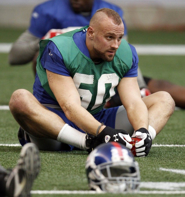 New York Giants linebacker Mark Herzlich (58) stretches during practice for the NFL Super Bowl XLVI in Indianapolis February 2, 2012.