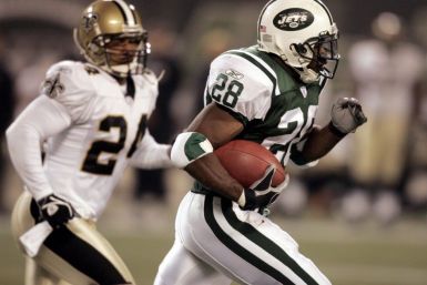 New York Jets running back Curtis Martin (28) passes 14,000 career yards as he rushes past New Orleans Saints safety Dwight Smith in East Rutherford, N.J., on November 27, 2005.