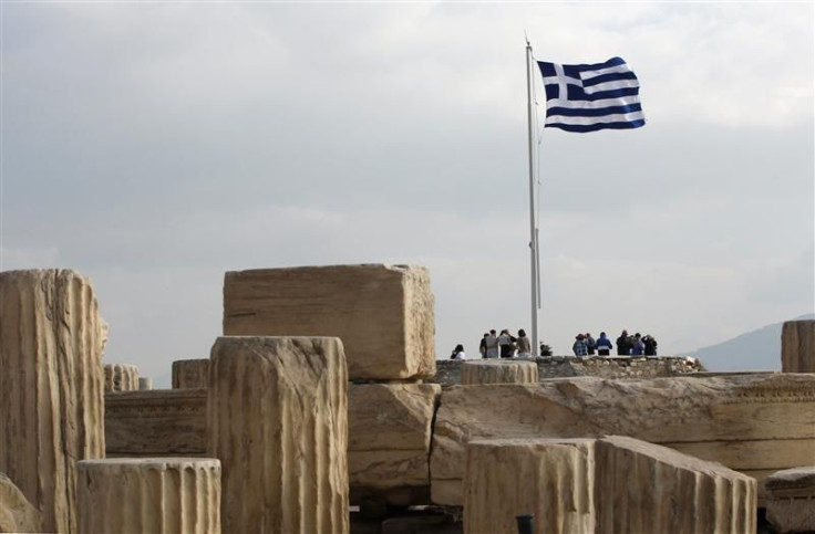A Greek national flag flies at the archaeological site of the Acropolis Hill in Athens
