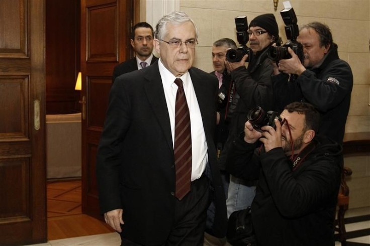 Prime Minister Lucas Papademos arrives at his office in Athens for a meeting with top Greek political leaders