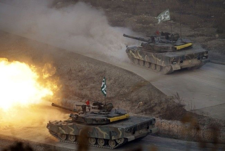 South Korea K-1 tanks fire live rounds during air and ground military exercises on the Seungjin Fire Training Field, in mountainous Pocheon December 23, 2010. 