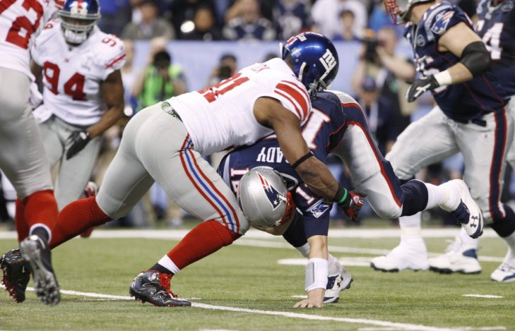 New England Patriots quarterback Tom Brady is sacked by New York Giants defensive end Justin Tuck in third quarter during the NFL Super Bowl XLVI football game in Indianapolis, Indiana
