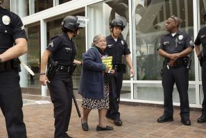 Julia Botello, 84 years old, is arrested for trespassing, along with 21 other protesters and homeowners facing foreclosure despite making payments under the Home Affordable Modification Program (HAMP). 