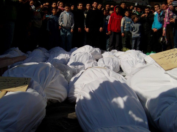 Residents attend a burial ceremony for what activists say are victims of shelling by the Syrian army