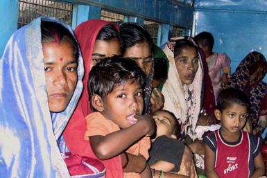 Bangladeshi women and children sit inside a crowded police van before appearing in court in Howrah, some 20 km (12 miles) west of the eastern Indian city of Calcutta