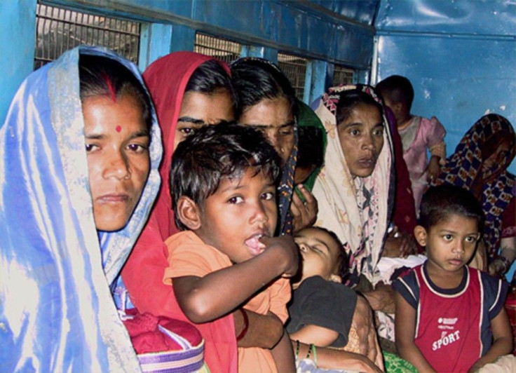 Bangladeshi women and children sit inside a crowded police van before appearing in court in Howrah, some 20 km (12 miles) west of the eastern Indian city of Calcutta