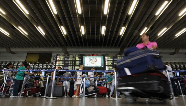 Passengers wait in line for ticketing at Guarulhos Airport in Sao Paulo