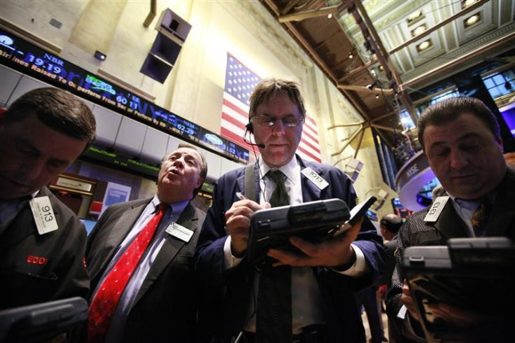 Traders gather at a post on the floor of the New York Stock Exchange