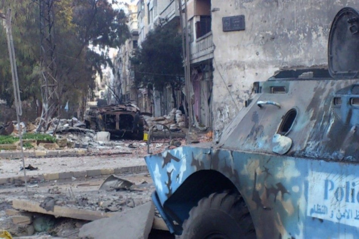 Two damaged armoured military vehicles are seen after clashes between President Bashar al-Assad forces and Free Syrian Army (FSA) in Cairo square near Khaldiyeh area in Homs