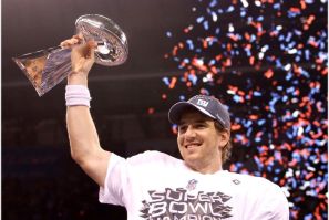 New York Giants quarterback Eli Manning holds up the Vince Lombardi Trophy after defeating the New England Patriots in the NFL Super Bowl XLVI football game in Indianapolis