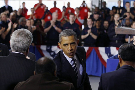 U.S. President Barack Obama shakes hands after speaking about the economy in Arlington