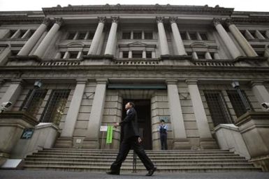 Man walks past Bank of Japan headquarters in Tokyo