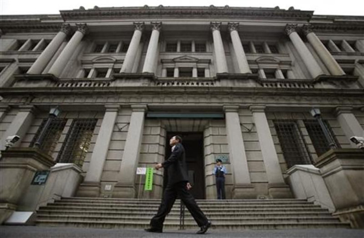 Man walks past Bank of Japan headquarters in Tokyo