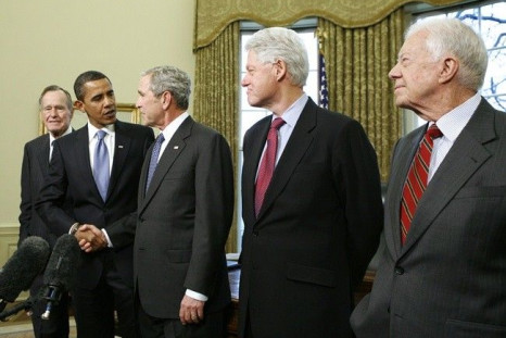 U.S. President George W. Bush (C) shakes hands with President-elect Barack Obama during a meeting with former U.S. Presidents in the Oval Office of the White House in Washington January 7, 2009. Also pictured are former President George H.W. Bush (L), for