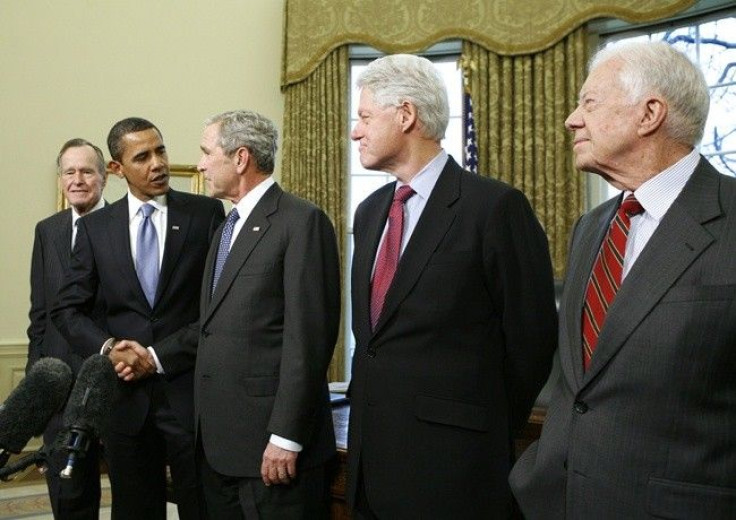 U.S. President George W. Bush (C) shakes hands with President-elect Barack Obama during a meeting with former U.S. Presidents in the Oval Office of the White House in Washington January 7, 2009. Also pictured are former President George H.W. Bush (L), for