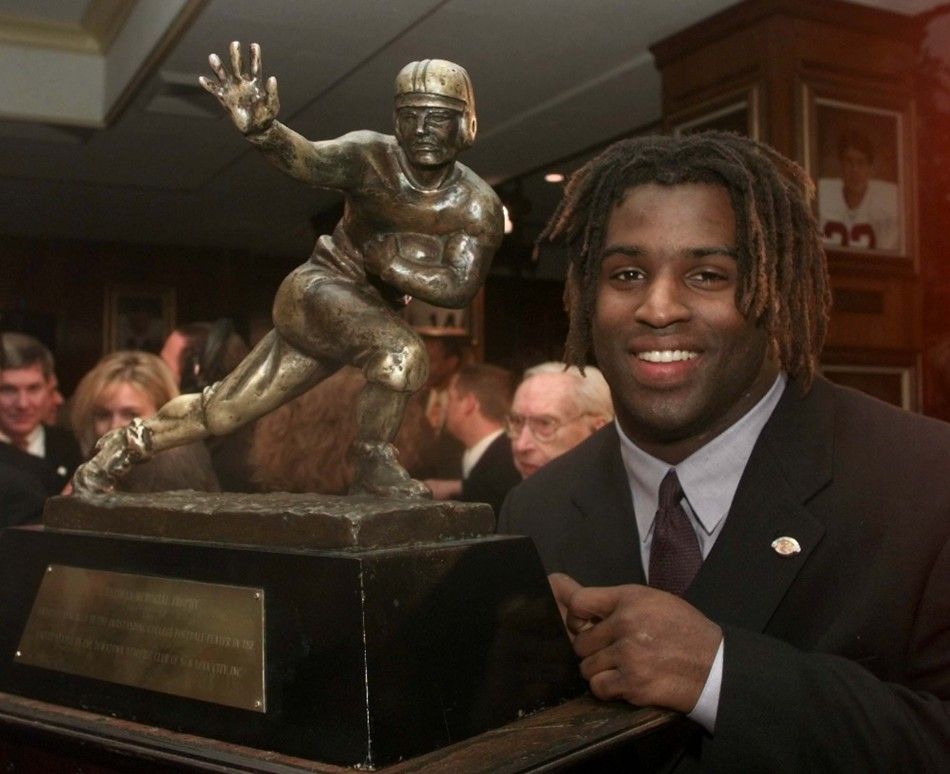 Texas running back Ricky Williams shows off the 1998 Heisman trophy after being named the top collegiate football player 