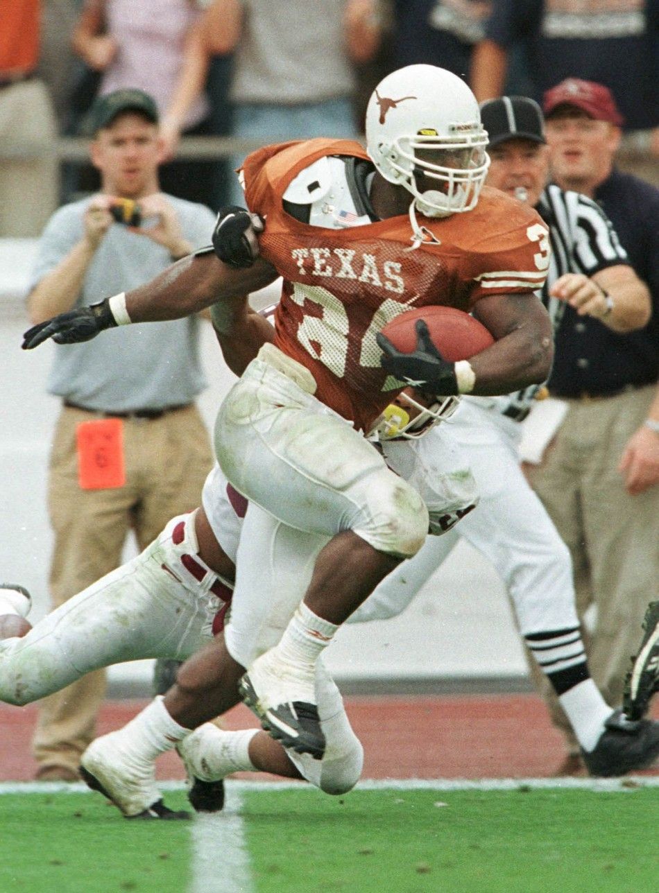 University of Texas Longhorns Ricky Williams heads toward the end zone for a 60-yard touchdown past Texas AM Aggies Jason Webster during first quarter action