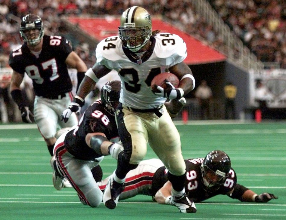 New Orleans Saints running back Ricky Williams breaks away from Atlanta Falcons defensive tackles Patrick Kearney 97, Travis Hall 98 and Shawn Sayda 93 on a 12-yard run for a touchdown in the first quarter