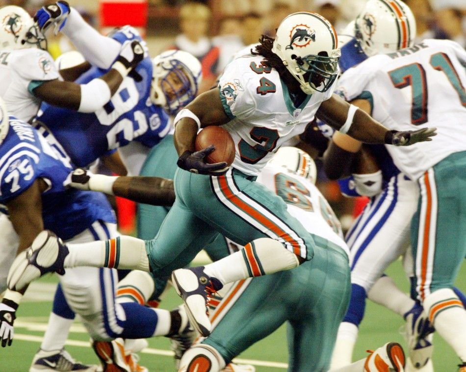 Miami Dolphins running back Ricky Williams 34 leaps over a potential tackler during first quarter play against the Indianapolis Colts at the RCA Dome in Indianapolis 
