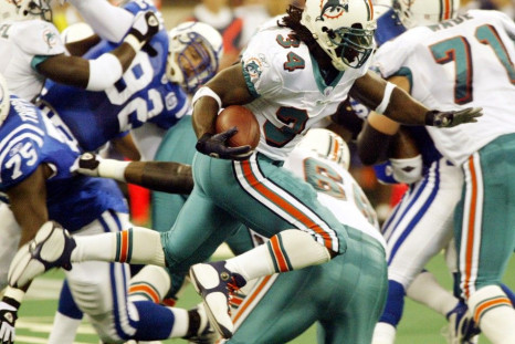 Miami Dolphins running back Ricky Williams (34) leaps over a potential tackler during first quarter play against the Indianapolis Colts at the RCA Dome in Indianapolis 
