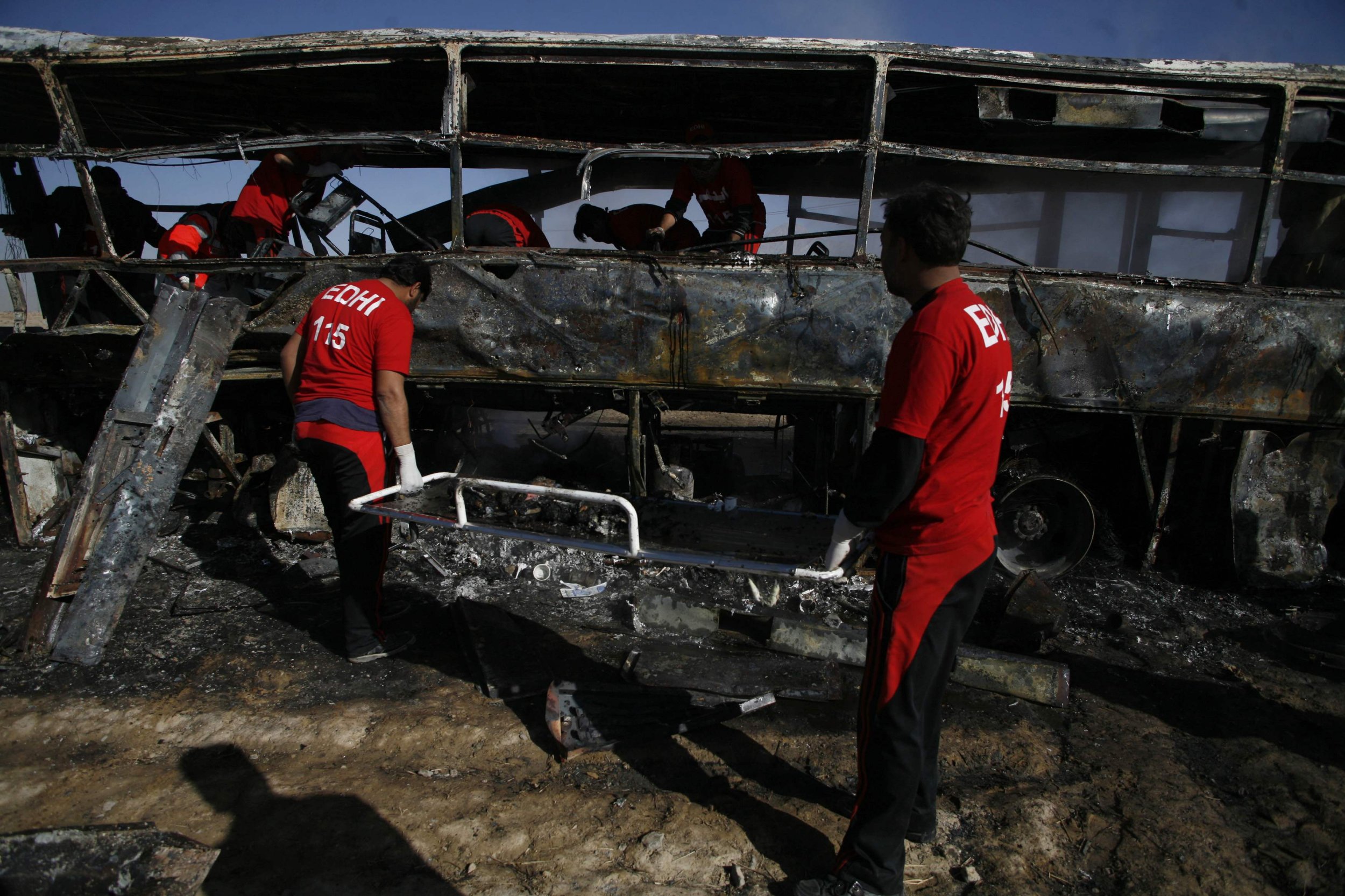 Emergency personnel transport burnt human remains on a stretcher after a car bomb exploded in Quetta