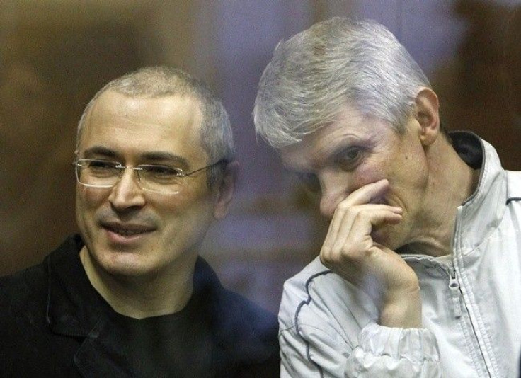 Jailed Russian former oil tycoon Mikhail Khodorkovsky and his business partner Platon Lebedev (R) stand in the defendants' cage before the start of a court session in Moscow December 28, 2010. 