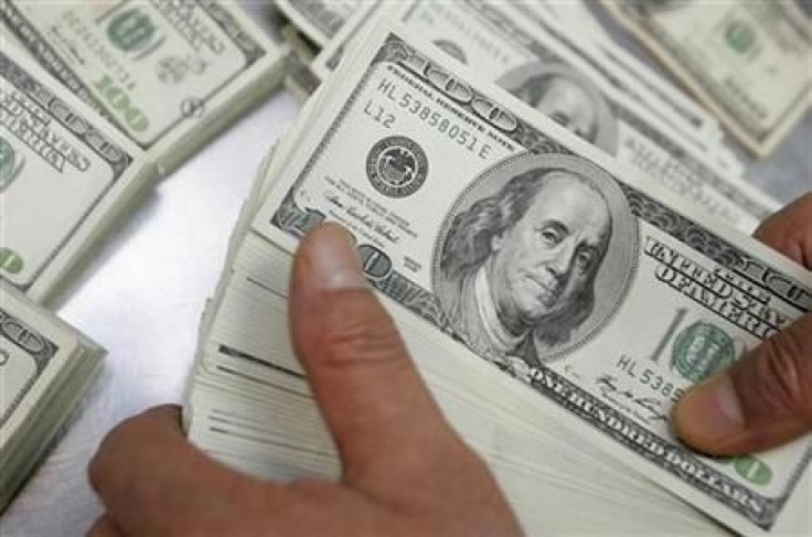 An employee of the Korea Exchange Bank counts one hundred dollar notes at the bank&#039;s headquarters in Seoul