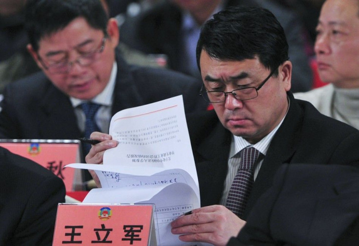 Deputy Mayor of Chongqing Wang reads documents as he attends a session of CPPCC of the Chongqing Municipal Committee, in Chongqing municipality