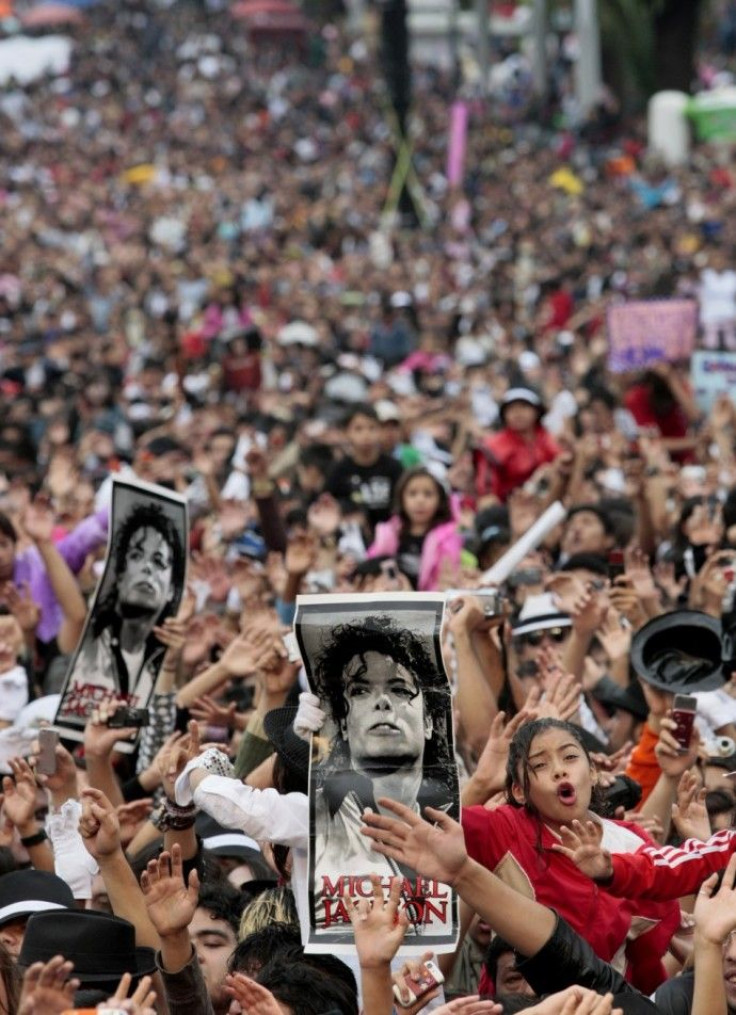 Michael Jackson fans hold up his poster in Mexico City August 29, 2009