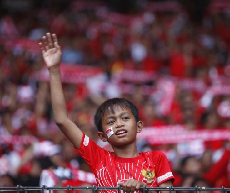 Young Indonesian fan cheers before start of final match against Malaysia during AFF Suzuki Cup 2010 soccer tournament in Jakarta