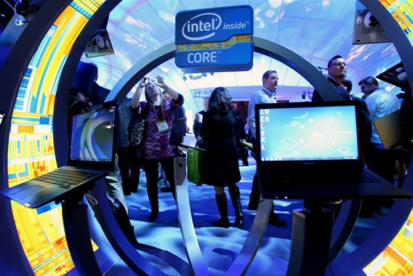 A woman takes a photo of ultrabooks at the Intel booth during the 2012 International Consumer Electronics Show in Las Vegas