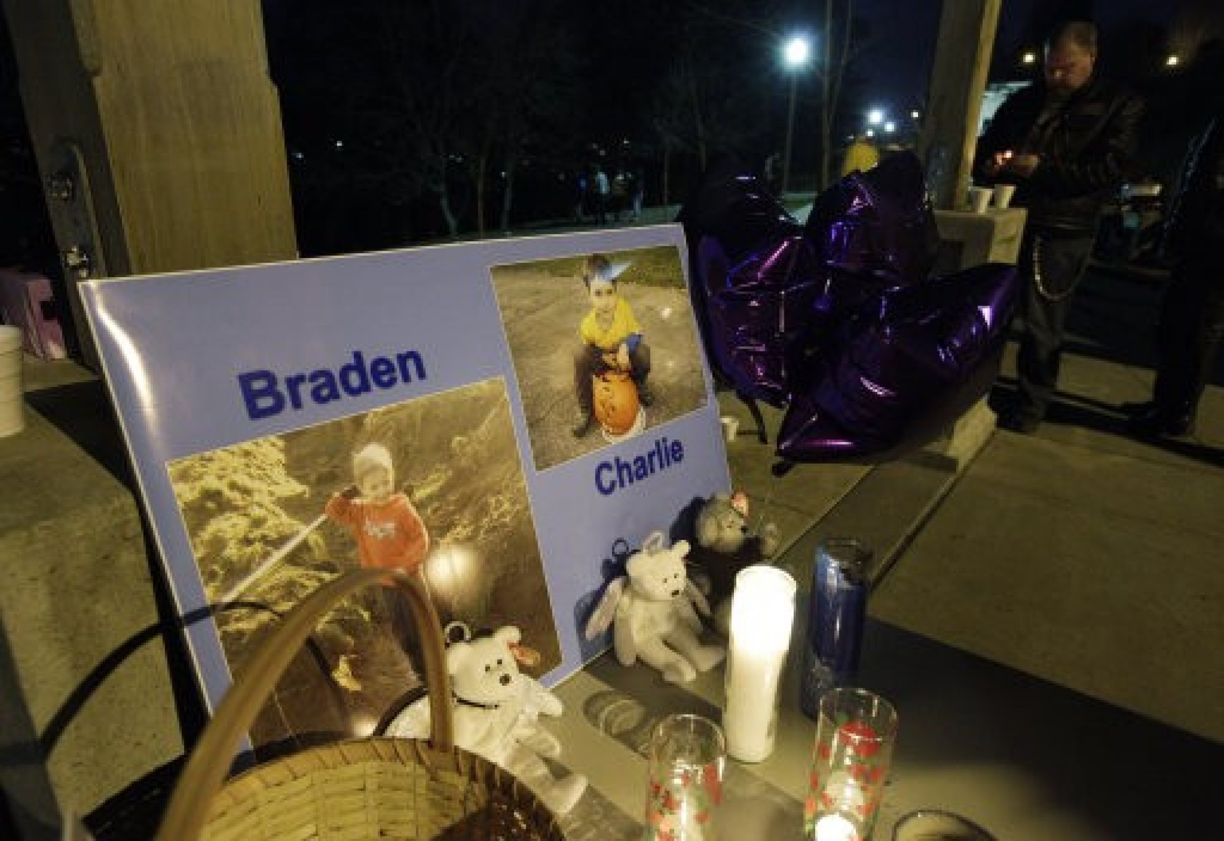 Photographs of Braden and Charlie Powell, the sons of Susan Cox Powell and Josh Powell, are displayed during a candlelight vigil at McKinley Park in Tacoma.