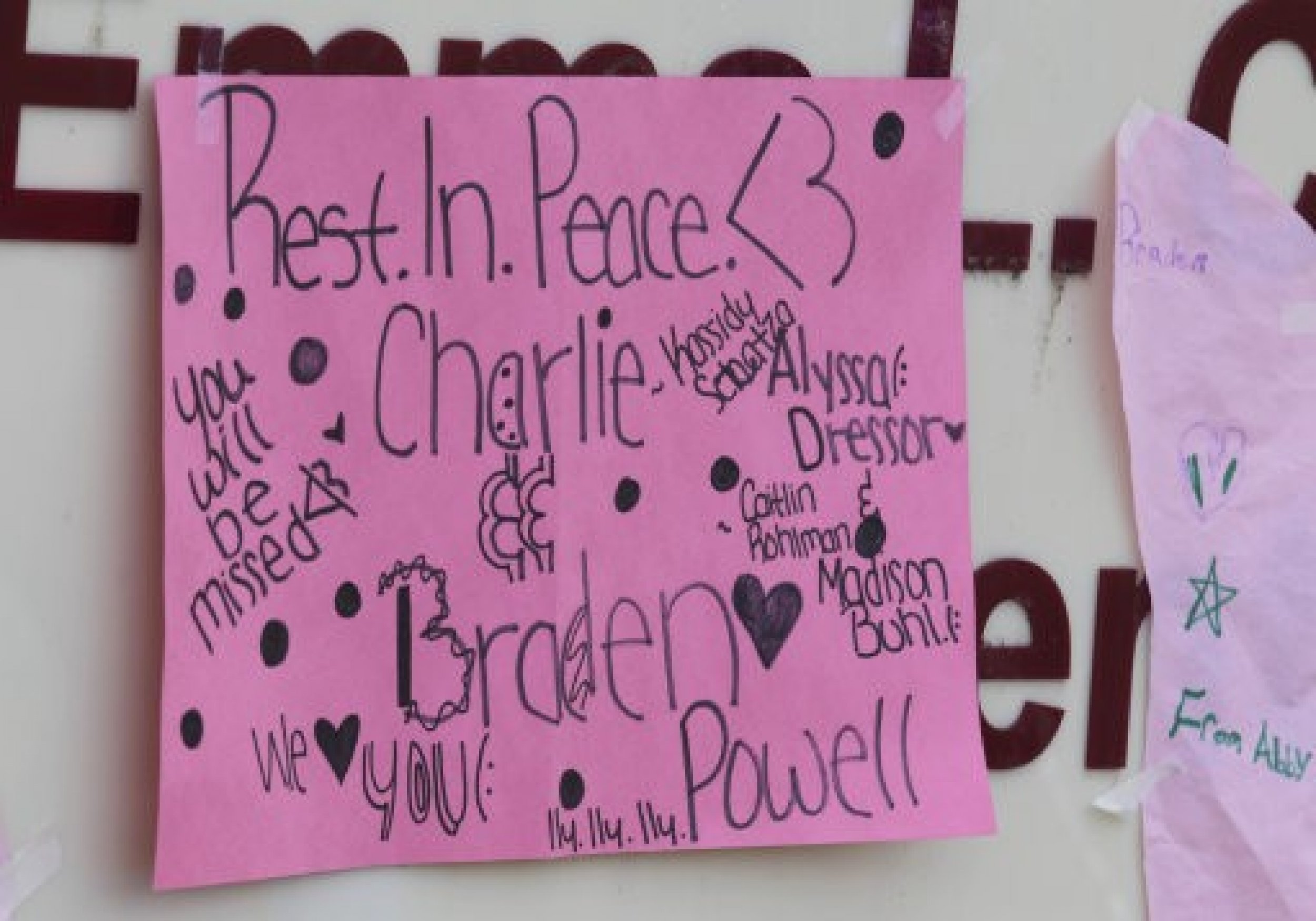 A sign in tribute to Charlie and Braden Powell is shown posted at a growing memorial, Tuesday, Feb. 7, 2012, at Carson Elementary School in Puyallup, Wash., where Charlie attended school.
