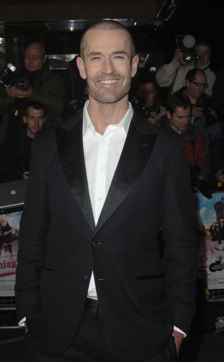British actor Rupert Everett poses at the world premiere of 'St Trinians' in London
