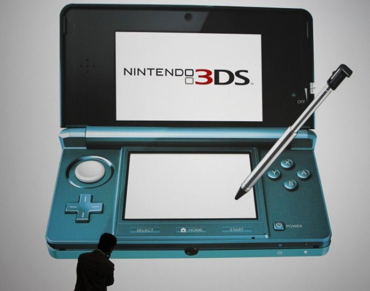 A man looks at a billboard of Nintendo Co Ltd's new 3DS handheld game console in Tokyo