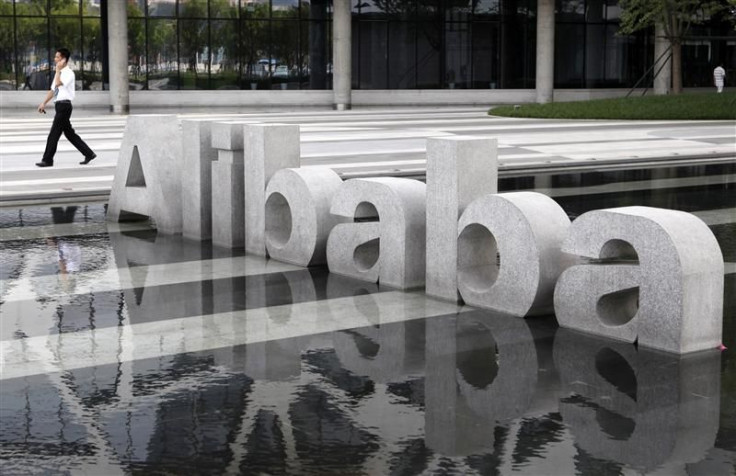 File photo of man walking past a logo of Alibaba (China) Technology Co. Ltd at its headquarters on the outskirts of Hangzhou
