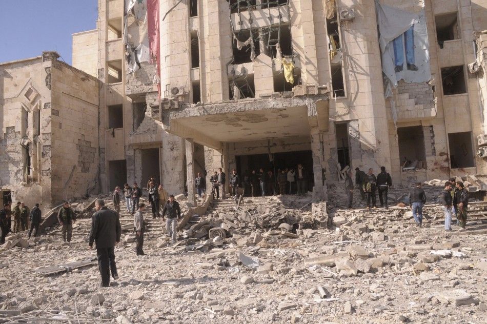 Syrian security personnel inspect the site of an explosion in Syrias northern city of Aleppo