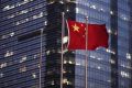 The Chinese national flag is seen in the financial district of Pudong in Shanghai